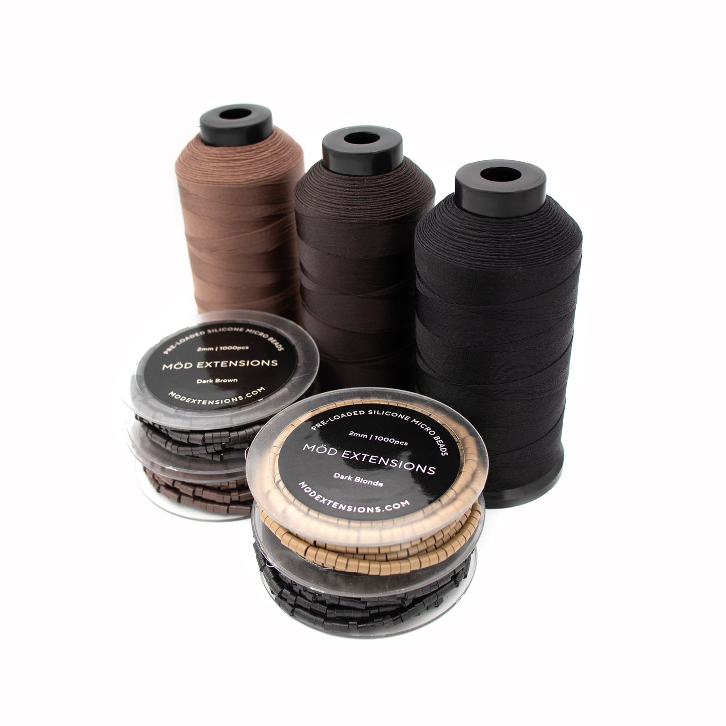 Set of four silicone micro beads with 3 spools of nylon thread  in different color options on a white background