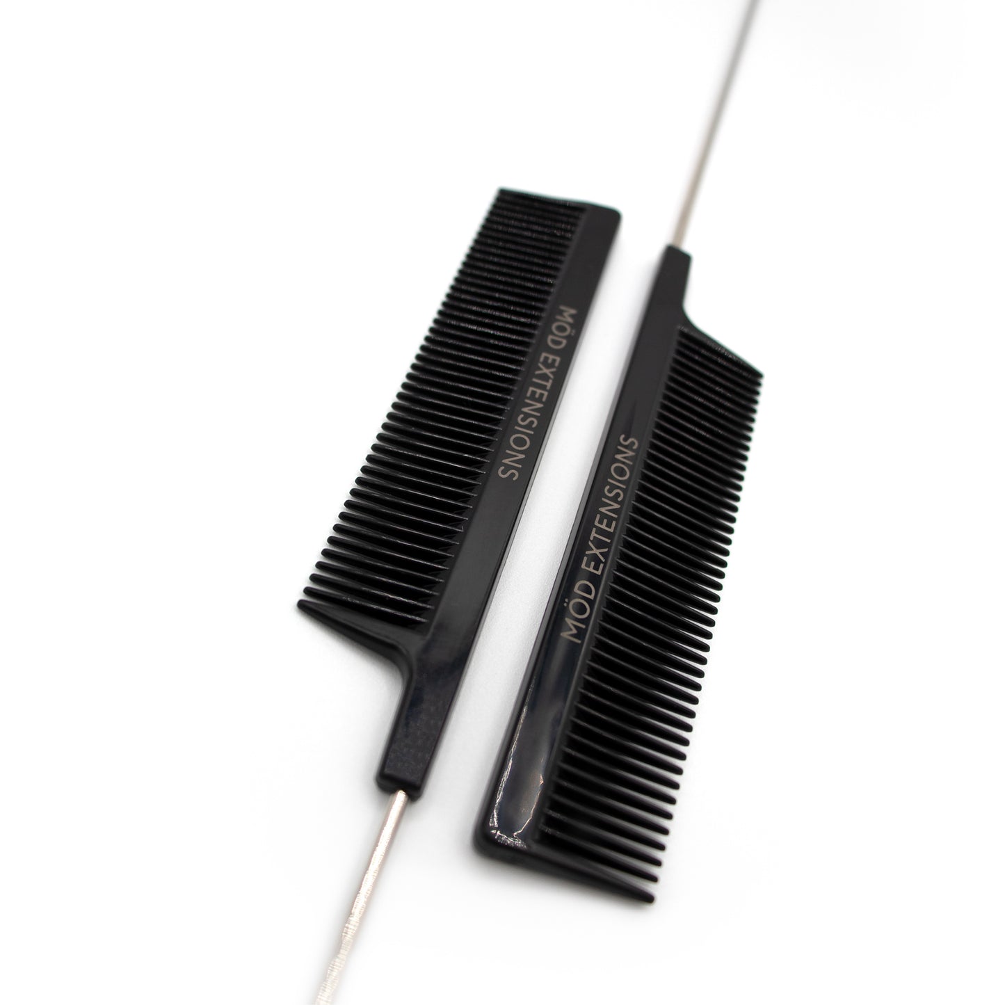Two black metal tail combs with 'MOD Extensions' branding on a white background